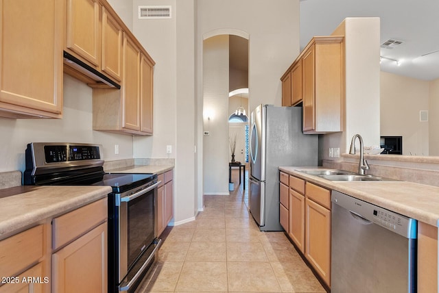 kitchen with visible vents, light brown cabinets, light countertops, a sink, and appliances with stainless steel finishes