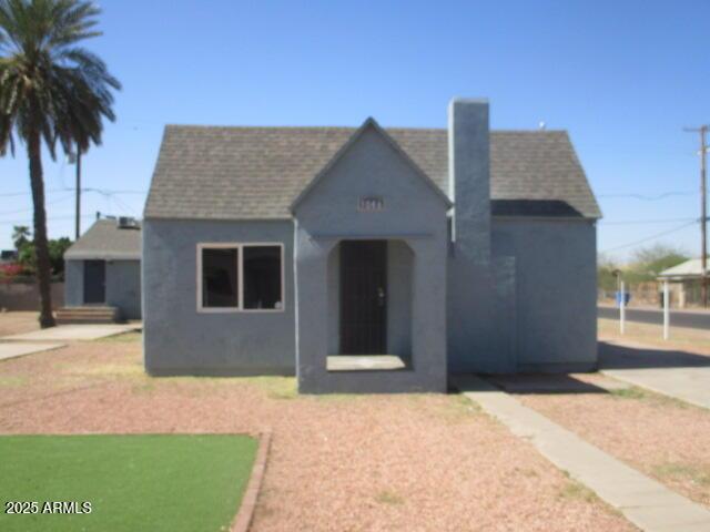 view of front of home featuring roof with shingles