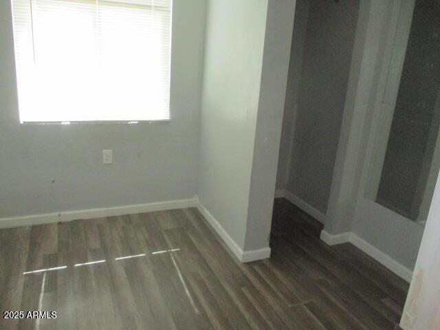 unfurnished room with wood finished floors and baseboards