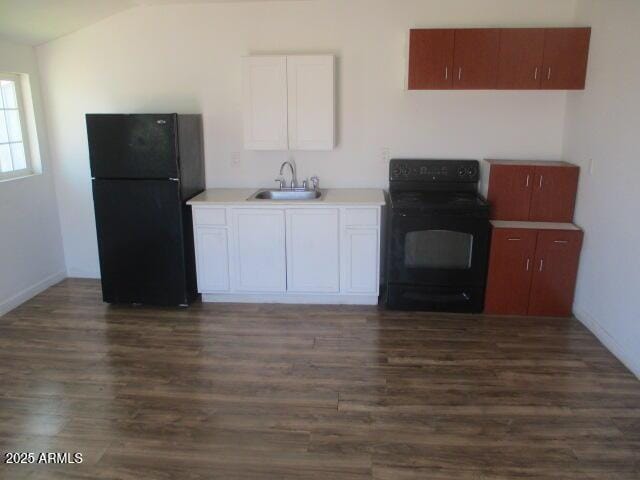 kitchen with dark wood-style floors, black appliances, a sink, and white cabinets