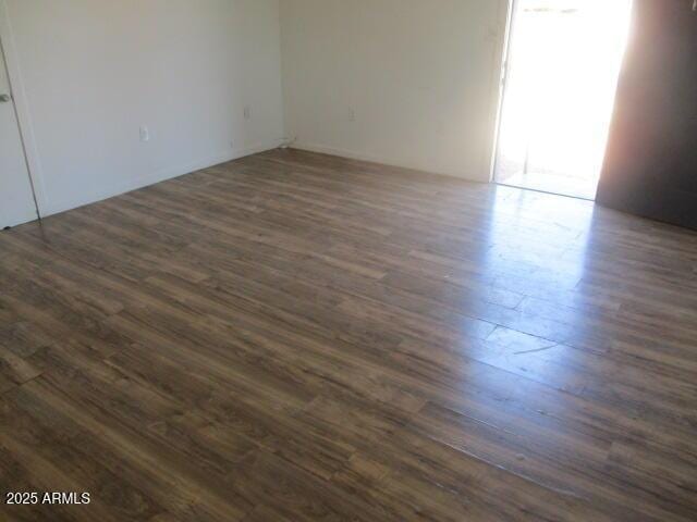 empty room featuring dark wood-type flooring