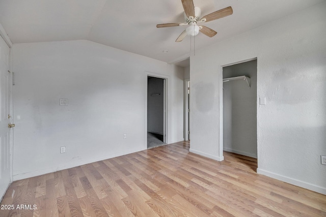 unfurnished bedroom with light wood-style floors, vaulted ceiling, baseboards, and a ceiling fan