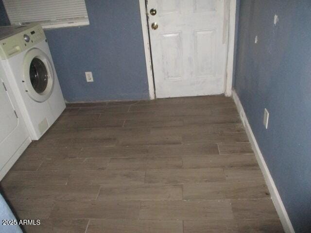 laundry room featuring washer / clothes dryer, wood finished floors, and baseboards