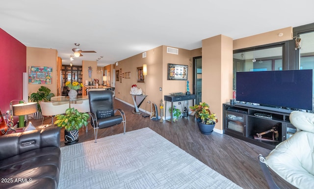 living room with hardwood / wood-style flooring and ceiling fan