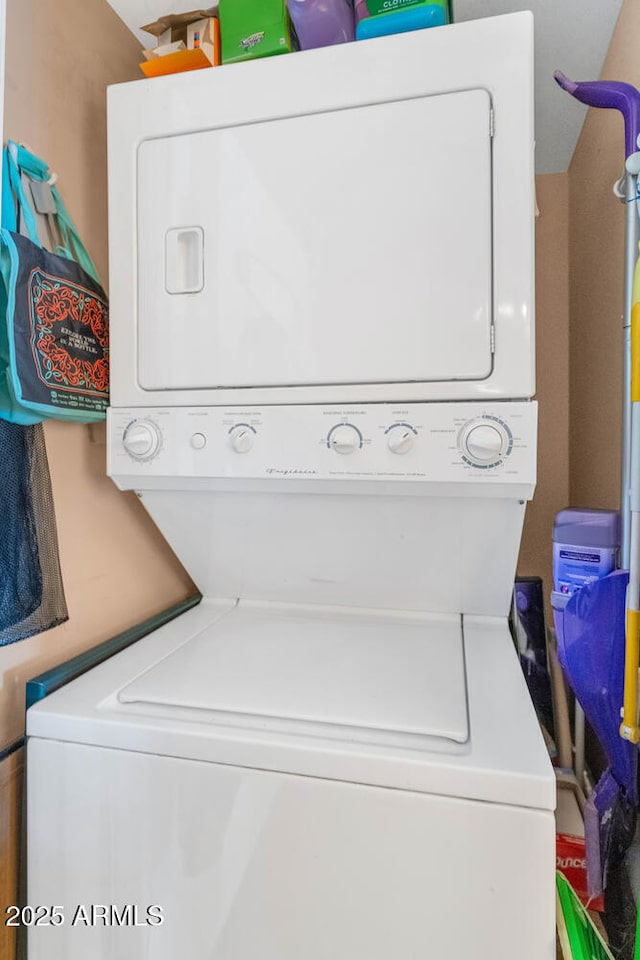 laundry area with stacked washer and clothes dryer