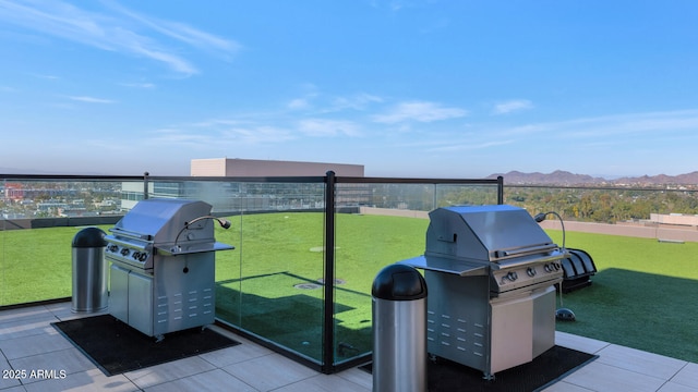 view of patio with area for grilling and a mountain view