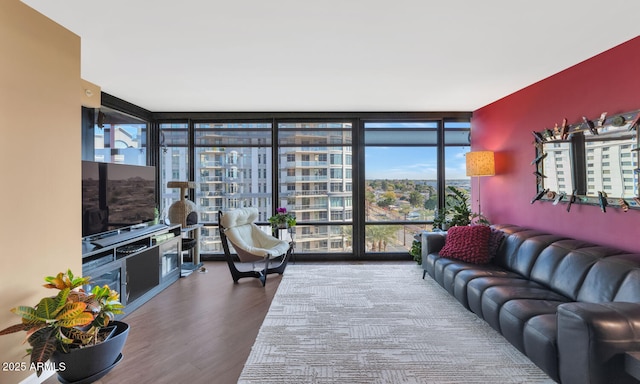 living room featuring wood-type flooring, a wealth of natural light, and a wall of windows