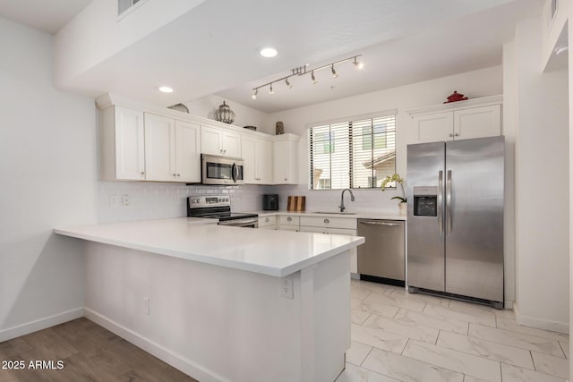 2315 N 52nd St Unit 144, Phoenix, AZ 85008 - kitchen with appliances with stainless steel finishes, white cabinets, a peninsula, light countertops, and tasteful backsplash