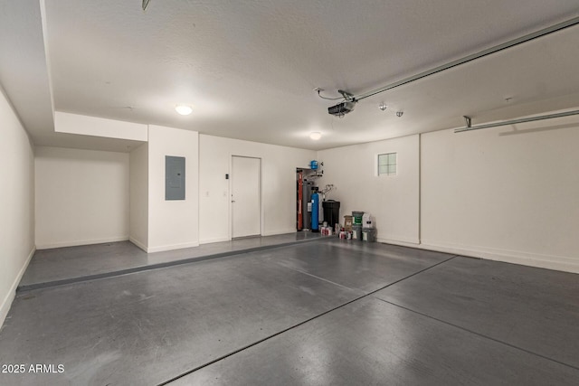 2315 N 52nd St Unit 144, Phoenix, AZ 85008 - garage featuring electric panel, a garage door opener, electric water heater, and baseboards
