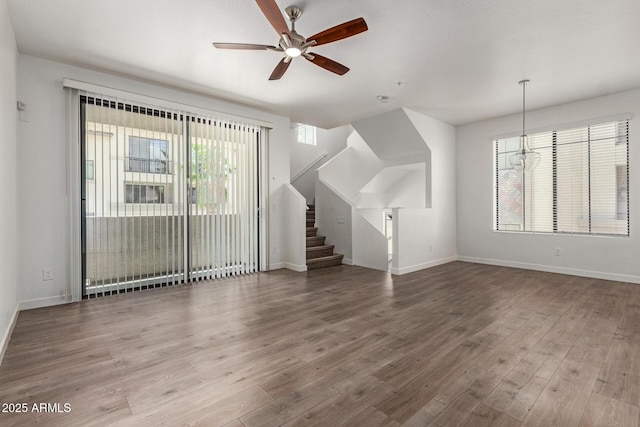 2315 N 52nd St Unit 144, Phoenix, AZ 85008 - unfurnished living room featuring ceiling fan, wood finished floors, and baseboards