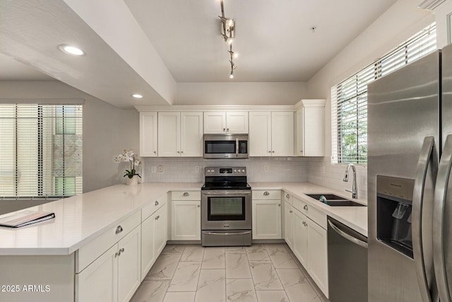 2315 N 52nd St Unit 144, Phoenix, AZ 85008 - kitchen featuring stainless steel appliances, a sink, light marble finish flooring, a peninsula, and recessed lighting