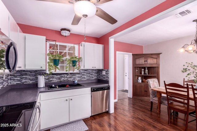 9603 N 1st Ave, Phoenix, AZ 85021 - kitchen featuring appliances with stainless steel finishes, a sink, dark countertops, a ceiling fan, and tasteful backsplash