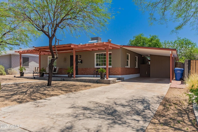 9603 N 1st Ave, Phoenix, AZ 85021 - ranch-style home with brick siding, a pergola, driveway, and a carport