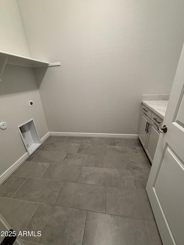 laundry room with cabinet space, electric dryer hookup, and baseboards