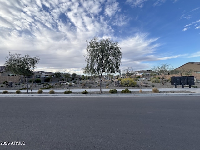 exterior space with curbs, sidewalks, and a residential view