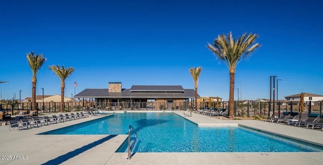 pool featuring a patio area and fence