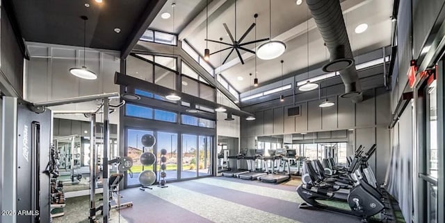 workout area with visible vents, plenty of natural light, and a high ceiling