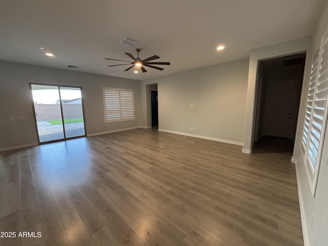 empty room featuring recessed lighting, visible vents, baseboards, and wood finished floors