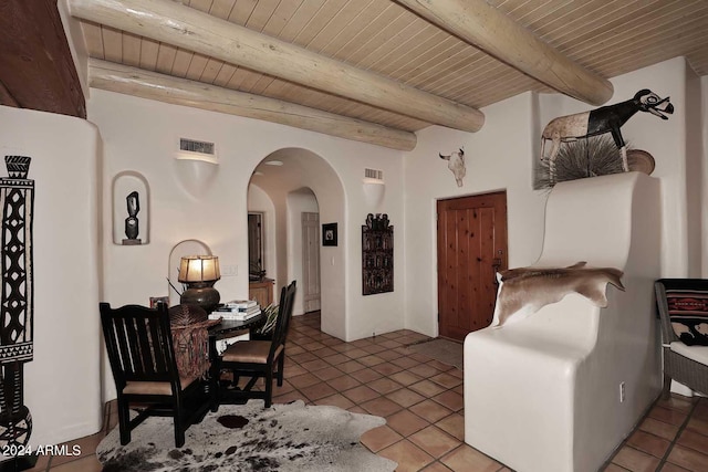 dining space featuring wood ceiling, beam ceiling, and tile patterned flooring