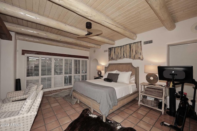 tiled bedroom featuring beam ceiling and wood ceiling