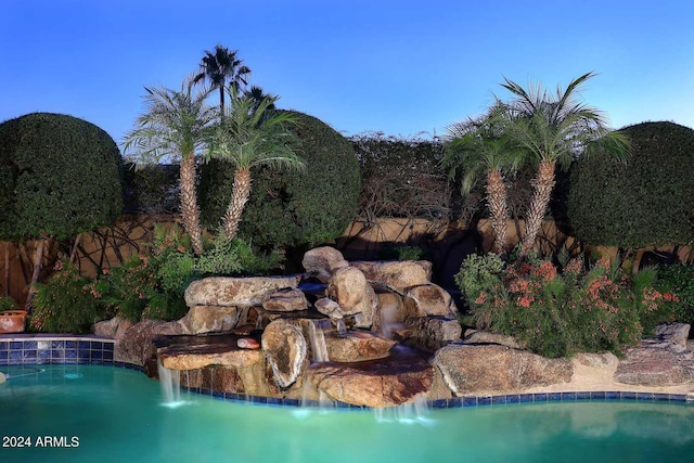 view of swimming pool featuring pool water feature