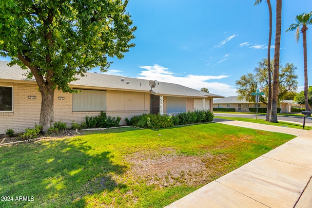 ranch-style home featuring a front yard