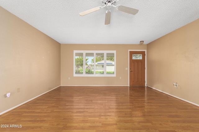 interior space featuring hardwood / wood-style floors, a textured ceiling, and ceiling fan