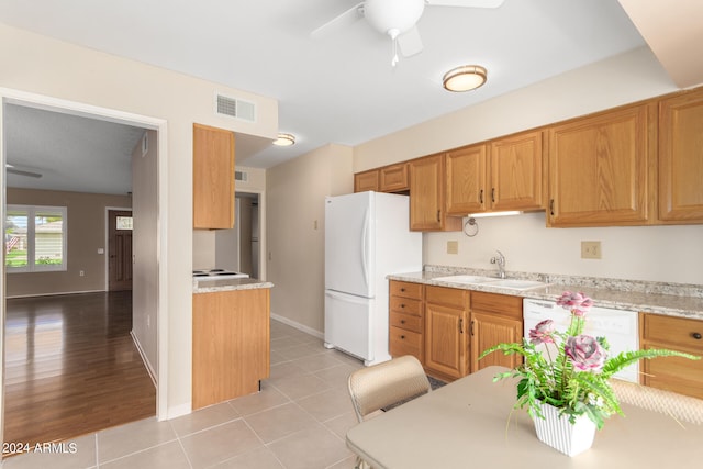 kitchen featuring light stone countertops, light wood-type flooring, white appliances, ceiling fan, and sink