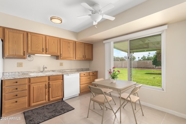 kitchen featuring light stone countertops, white dishwasher, ceiling fan, sink, and light tile patterned floors