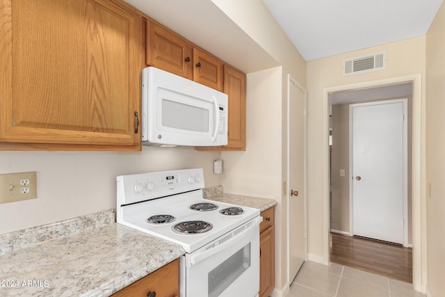 kitchen with light hardwood / wood-style floors and white appliances