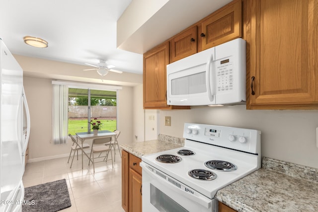 kitchen with light tile patterned floors, white appliances, and ceiling fan