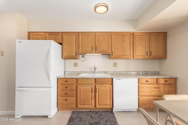 kitchen with light stone countertops, white appliances, sink, and light tile patterned floors