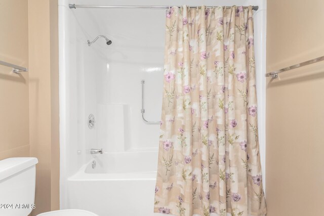 bathroom with shower / bath combo and toilet