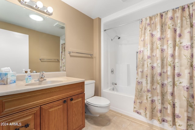 full bathroom with tile patterned floors, shower / bathtub combination with curtain, vanity, and toilet