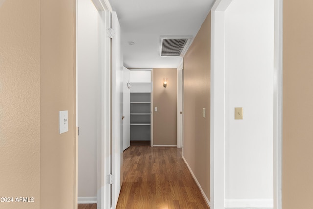 corridor with hardwood / wood-style floors