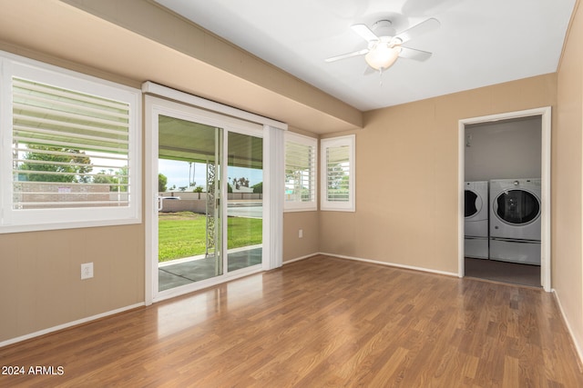 empty room featuring wood-type flooring, ceiling fan, and washing machine and clothes dryer