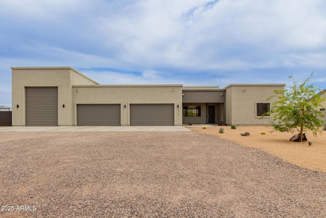 2516 W Joy Ranch Rd, Phoenix, AZ 85086 - pueblo-style house with driveway, stucco siding, and a garage