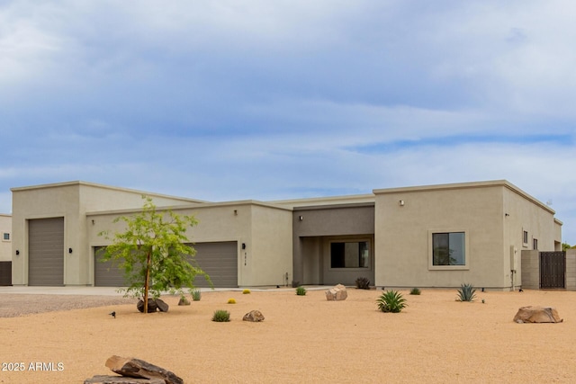 2516 W Joy Ranch Rd, Phoenix, AZ 85086 - adobe home featuring an attached garage, driveway, and stucco siding