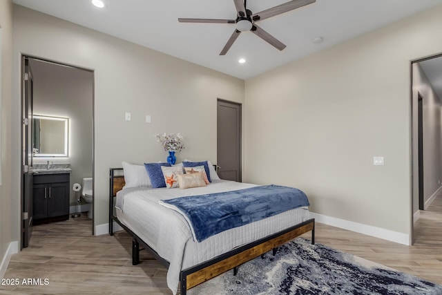 2516 W Joy Ranch Rd, Phoenix, AZ 85086 - bedroom with light wood-style floors, recessed lighting, baseboards, connected bathroom, and a sink