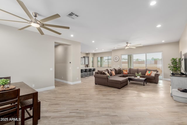 2516 W Joy Ranch Rd, Phoenix, AZ 85086 - living room with ceiling fan, light wood finished floors, baseboards, and recessed lighting