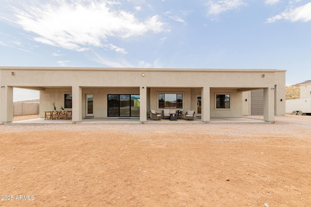 2516 W Joy Ranch Rd, Phoenix, AZ 85086 - rear view of property featuring stucco siding, a patio, and an outdoor living space