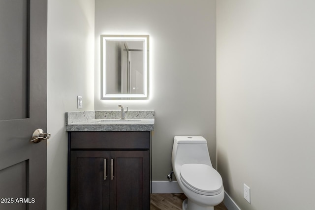 2516 W Joy Ranch Rd, Phoenix, AZ 85086 - half bath with vanity, toilet, baseboards, and wood finished floors