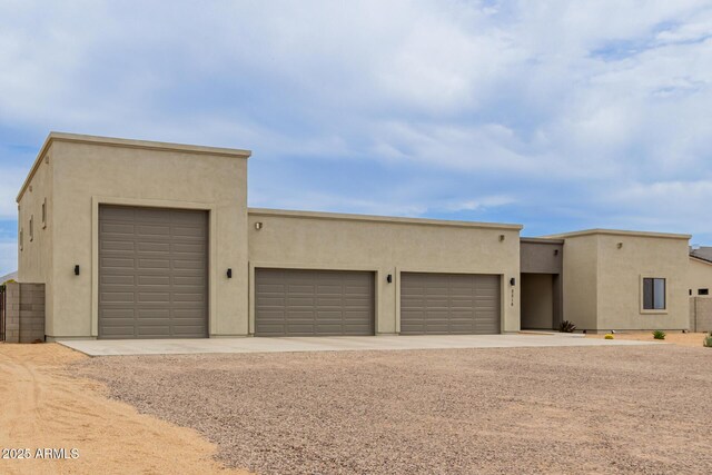 2516 W Joy Ranch Rd, Phoenix, AZ 85086 - southwest-style home featuring dirt driveway, stucco siding, and an attached garage