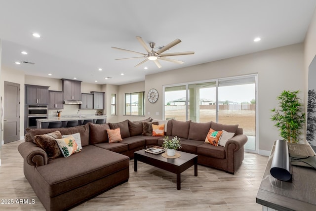 2516 W Joy Ranch Rd, Phoenix, AZ 85086 - living area featuring a ceiling fan, recessed lighting, light wood-style floors, and baseboards