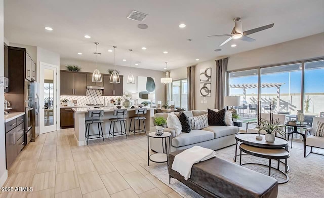 16336 W Jackson St, Goodyear, AZ 85338 - living area with healthy amount of natural light, a ceiling fan, and recessed lighting
