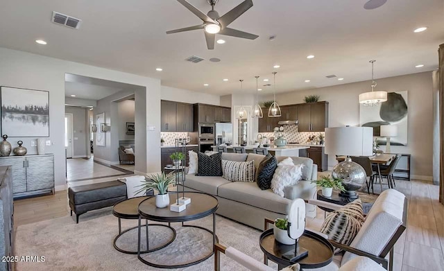 16336 W Jackson St, Goodyear, AZ 85338 - living room featuring a ceiling fan, recessed lighting, and light wood finished floors
