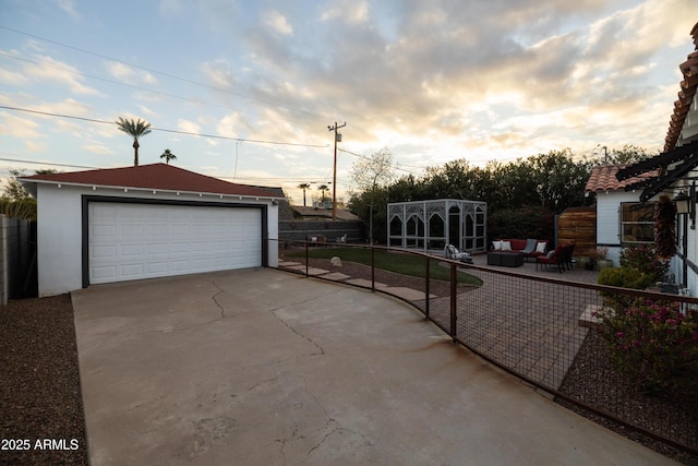 view of garage at dusk