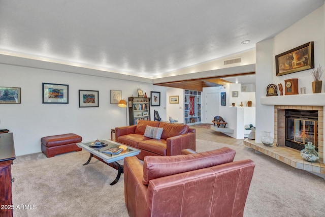living room featuring carpet floors and a tile fireplace