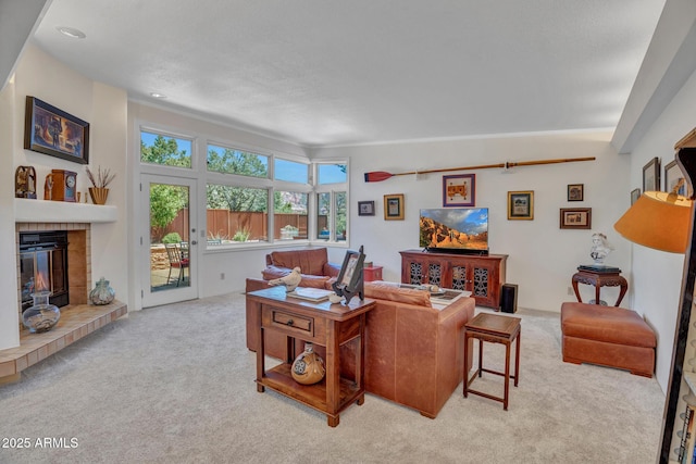 living area featuring carpet flooring and a fireplace