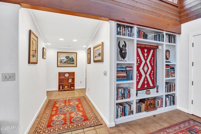 hallway with crown molding, tile patterned flooring, recessed lighting, baseboards, and built in shelves